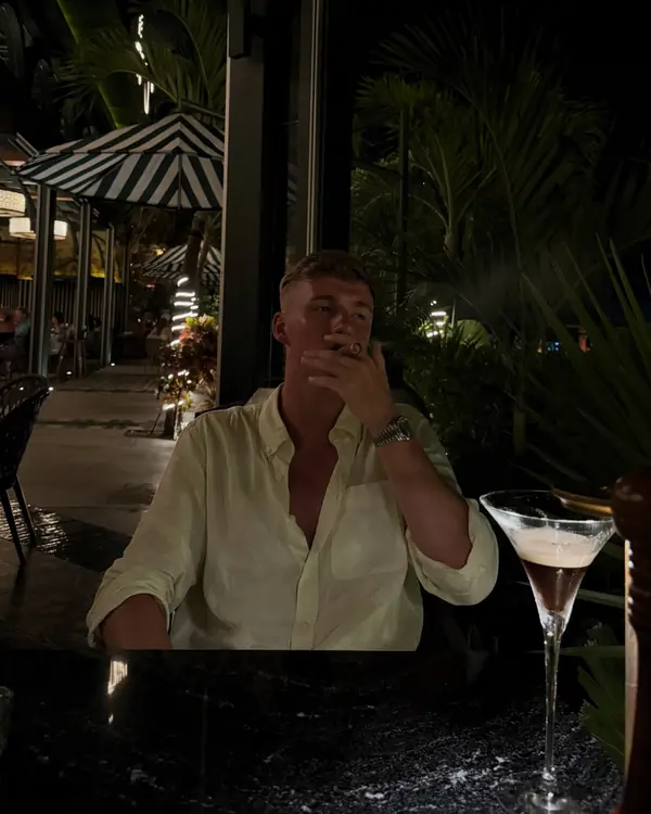 Leon at dinner on a restaurant terrace at night