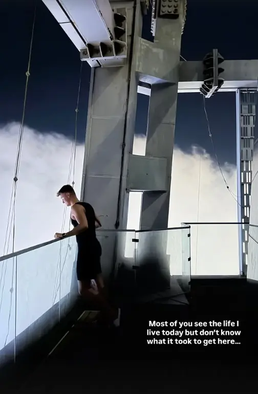 Leon looking out over the clouds from a high viewing deck